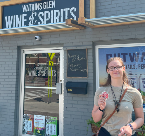 Image showing teen that designed the sticker standing in front of a store holding the sticker